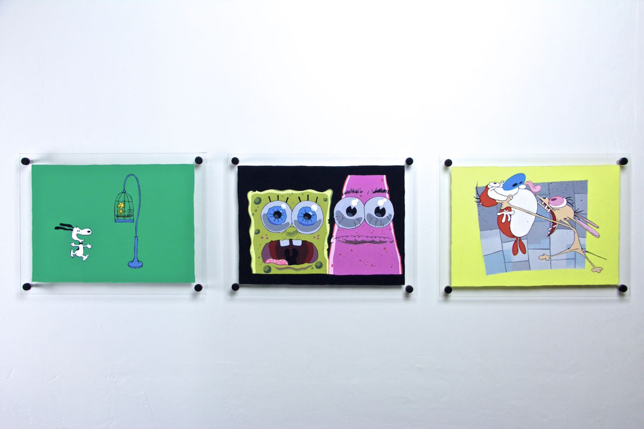 a painting of Snoopy and Woodstock, a painting of Spongebob Squarepants and Patrick, and a painting of Ren and Stimpy, hanging on a wall together